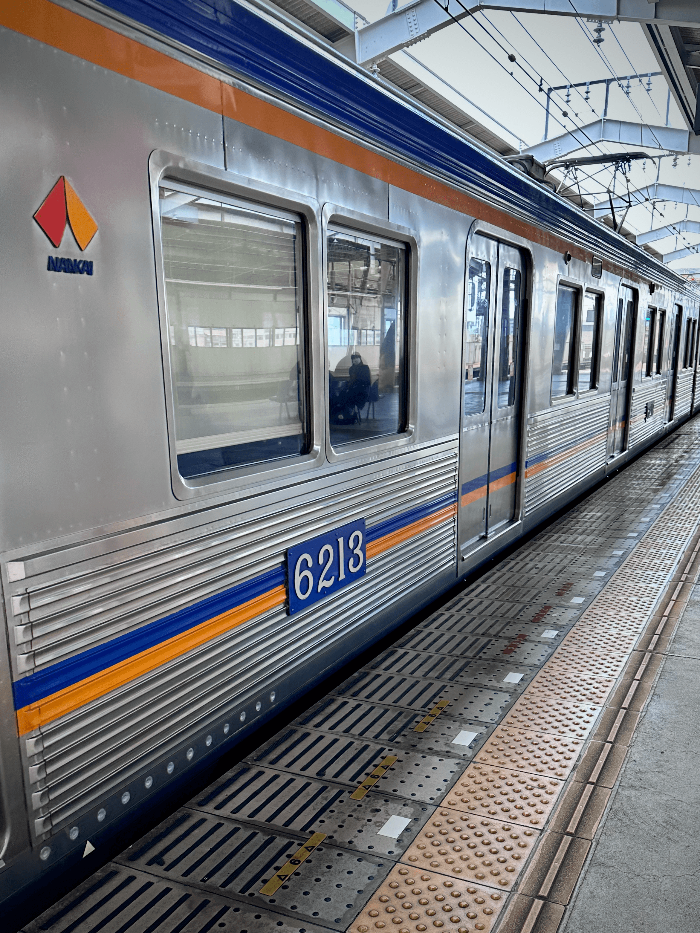 Osaka metro train departing at a station in Japan